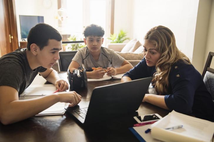Mother homeschooling teenage boys